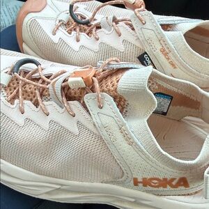 Hoka Cream and Orange Athletic Shoes